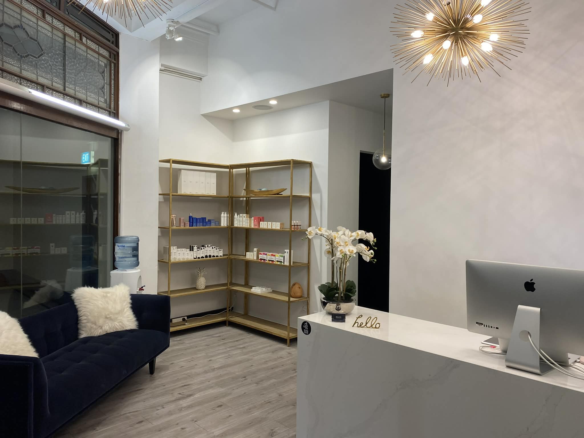Beauty on Park Street reception with marble counter, gold shelving, and heritage windows in the Dymocks Building